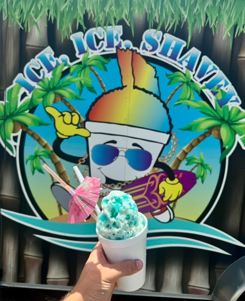 Cotton candy blue shaved ice in front of Ice Ice Shavey logo