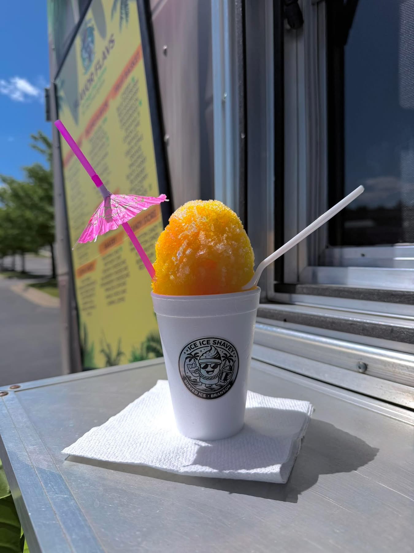 Bright mango shaved ice with paper umbrella