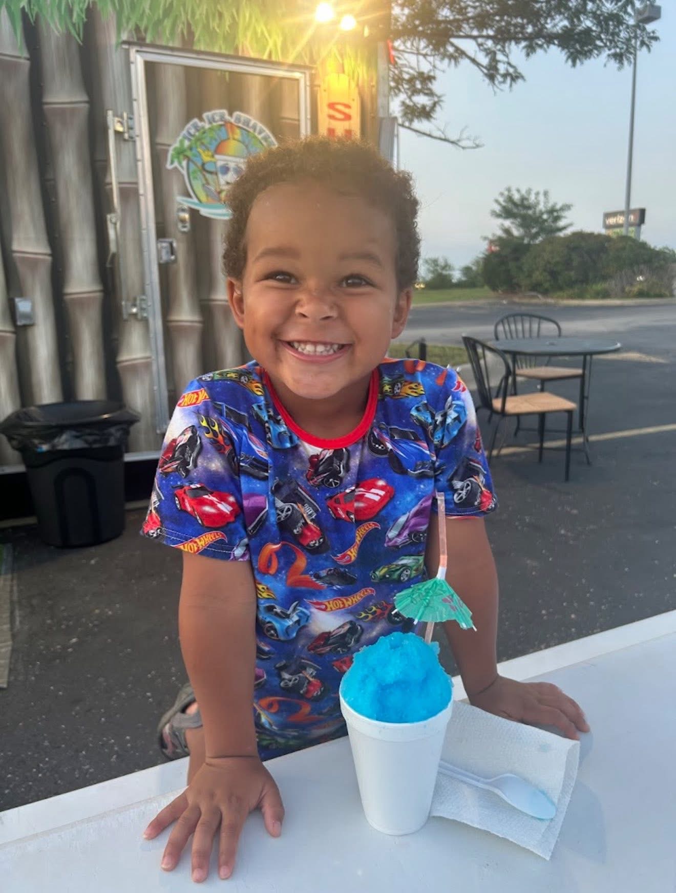 Smiling child with blue shaved ice
