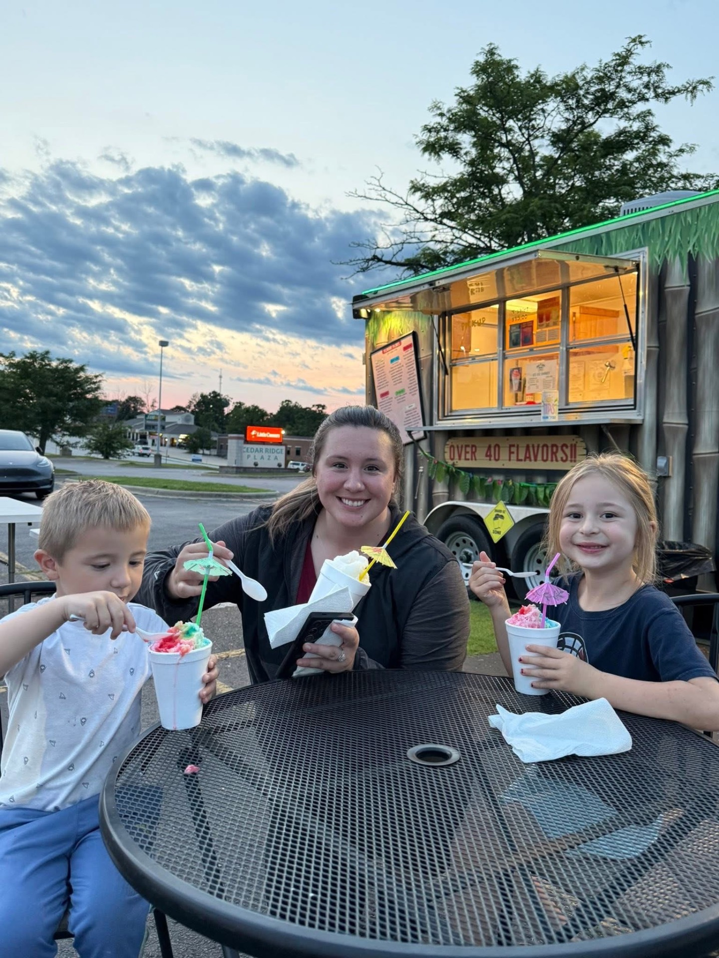 Kids and mom at the food truck at sunset